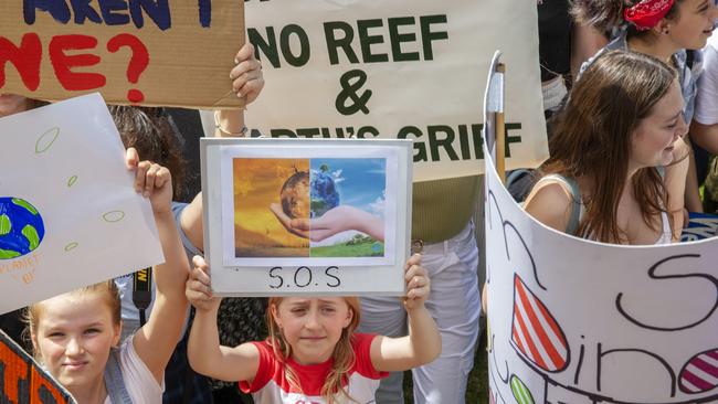 A young girl holds up an SOS banner in The Domain ahead of a climate rally last week in Sydney. Picture: Getty Images