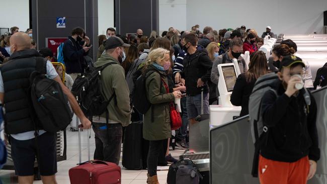 Passengers lining up for flights at Melbourne Airport. Picture: Tony Gough