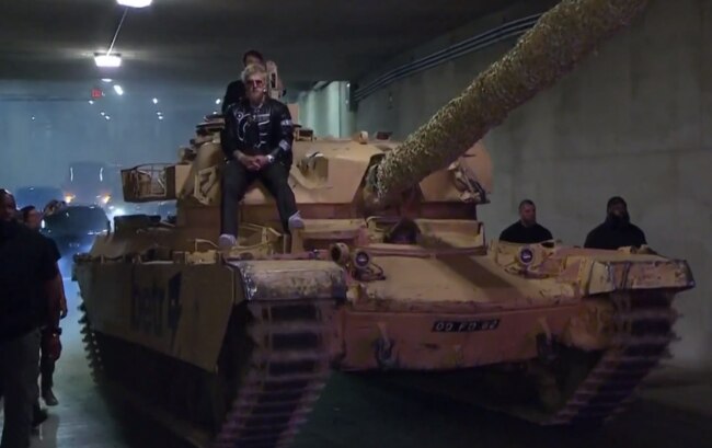 Jake Paul riding a tank.