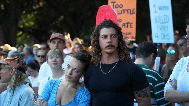 Abbie Chatfield and Adam Hyde join demonstrators during a national rally against violence towards women in Sydney. Picture: Lisa Maree Williams/Getty Images.