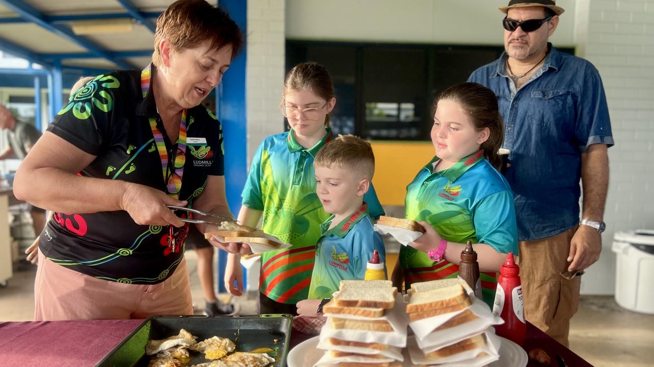 Principal Carol Putica serves up an egg and bacon sanga. Students at Ludmilla Primary School celebrated their return for the new school year with a parents and kids breakfast. Picture: Fia Walsh.