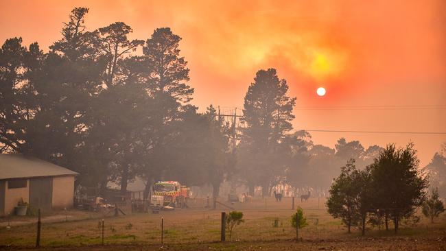 Dawn breaks across the Blue Mountains on Monday as the damage from Sunday’s firestorm becomes apparent. Picture: Matrix