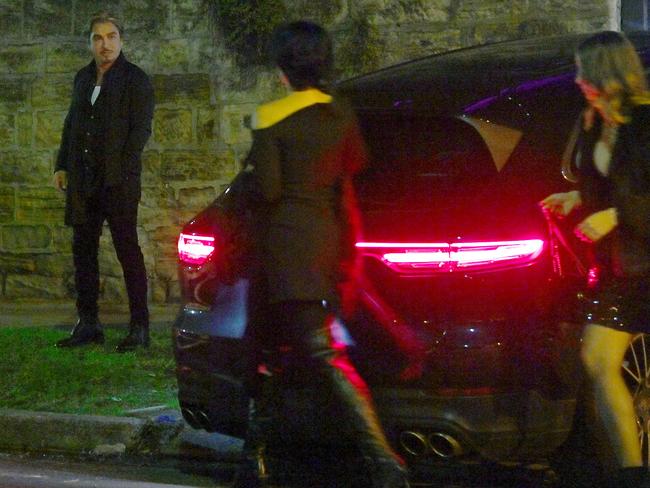 John Ibrahim waits for partner Sarah Budge and a friend at Sandilands’ Woollahra mansion on Saturday night. Picture: Jeremy Piper