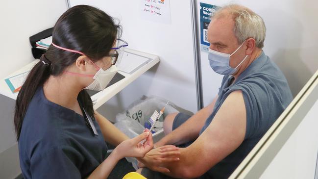 A man receives his booster Covid shot. Picture: David Crosling