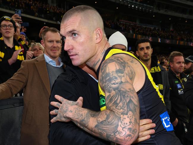 MELBOURNE, AUSTRALIA - JUNE 15: Dustin Martin of the Tigers embraces his agent Ralph Carr following his 300th match the round 14 AFL match between Richmond Tigers and Hawthorn Hawks at Melbourne Cricket Ground on June 15, 2024 in Melbourne, Australia. (Photo by Graham Denholm/Getty Images)