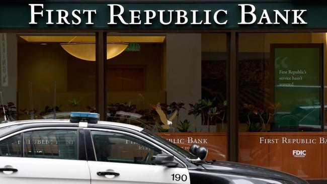 A San Francisco police officer sits parked in his car in front of First Republic Bank headquarters. Picture: AFP.