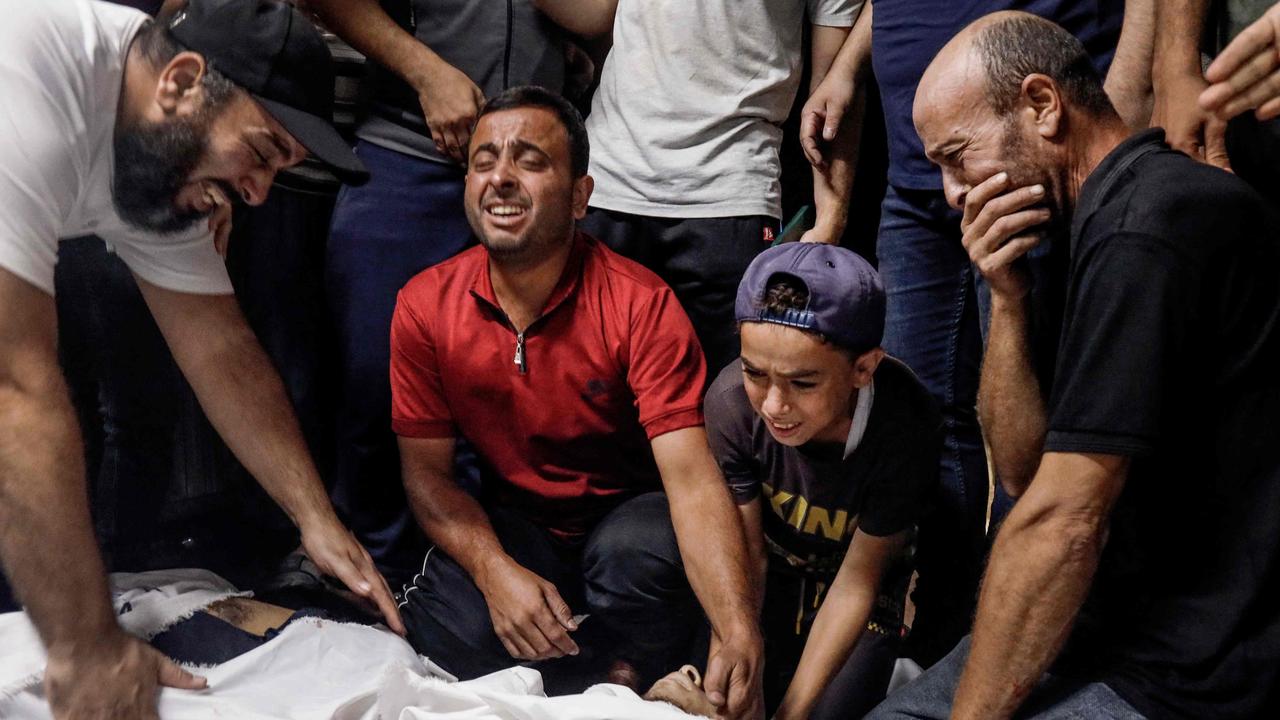 Family members and relatives mourn over the bodies of Palestinian militants killed in the latest infiltration operation into Israel. Picture: AFP