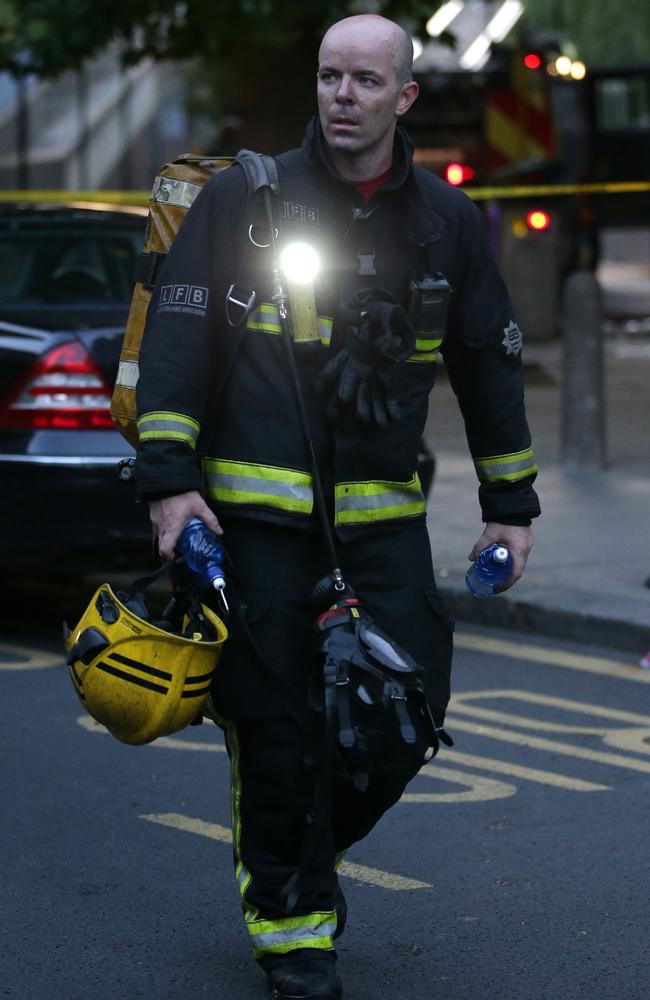 A firefighter on the scene of the horrific Grenfell Tower fire. Picture: AFP