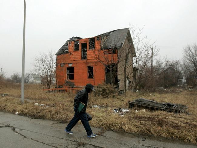 An abandoned Detroit home painted bright orange by artists hoping to draw attention to the city’s many eyesores. Picture: Jeff Kowalsky