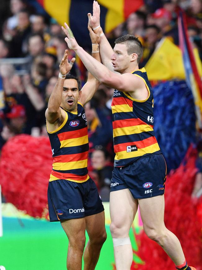 Josh Jenkins, who kicked the match-winner in Showdown 45, celebrates with Eddie Betts. Picture: AAP Image/David Mariuz