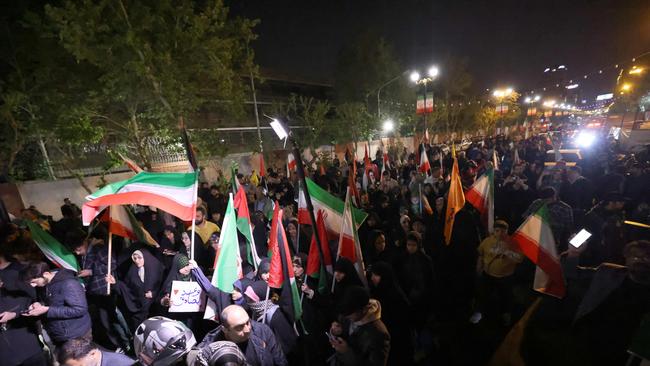 Iranians gather at the British embassy in Tehran on Saturday night. Picture: AFP