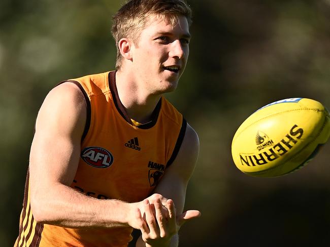 MELBOURNE, AUSTRALIA - MAY 06: Dylan Moore  of the Hawks handballs during a Hawthorn Hawks AFL training session at Waverley Park on May 06, 2022 in Melbourne, Australia. (Photo by Quinn Rooney/Getty Images)