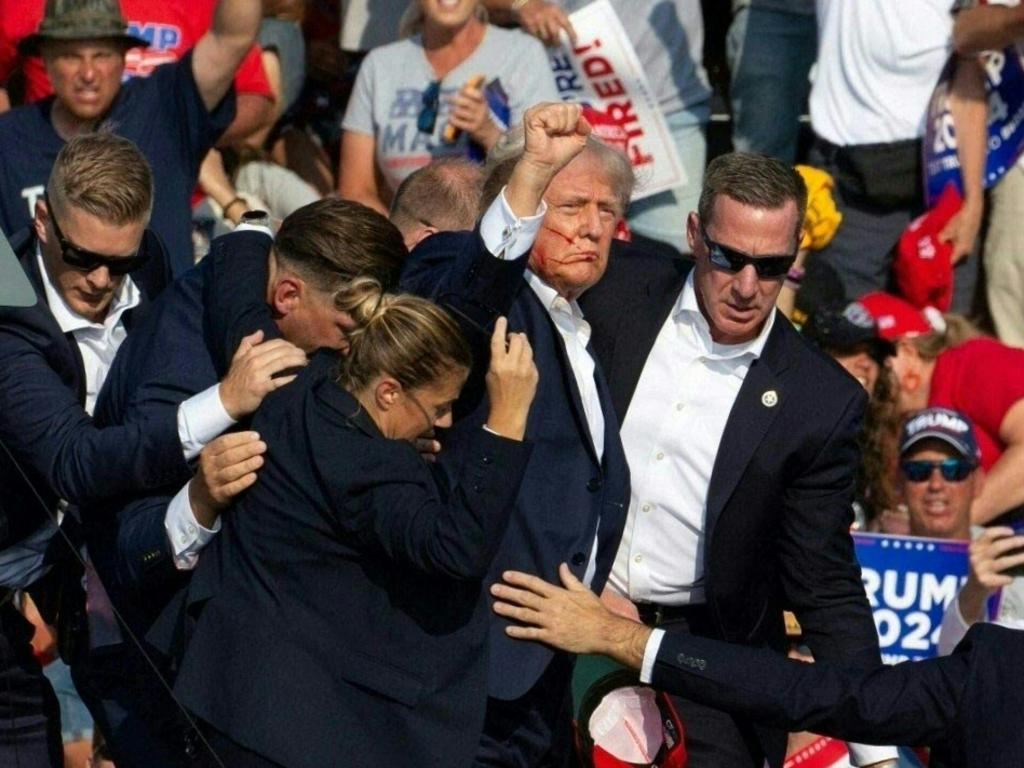 Donald Trump is seen with blood on his face surrounded by Secret Service agents after he was shot at his campaign rally in Butler, Pennsylvania on July 13. Picture: Rebecca Droke/AFP