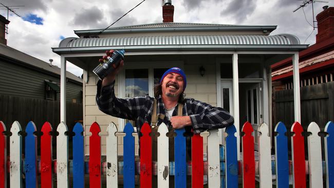 Jimmy Best has painted his fence in red white and blue. Picture: Aaron Francis