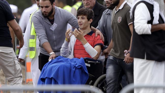 A grieving Zaed Musta, injured in the mosque attacks, arrives in a wheelchair for the funerals of his brother, Hamza and father, Khalid Mustafa, who were killed by the gunman. Picture: Mark Baker/AP