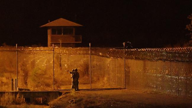 Armed police officers outside the centre at the height of the stand-off. Picture: Keri Megelus