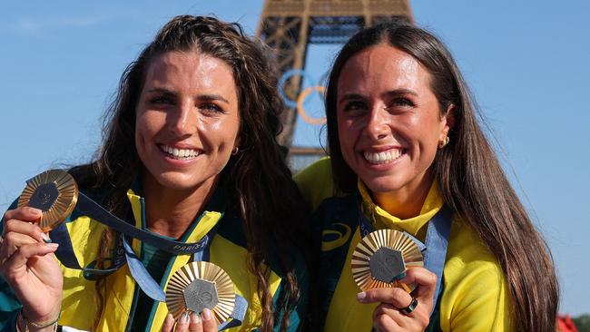 Australia's gold medallists and Jessica and Noemie Fox pose with their medals on stage at the Champions Park at Trocadero during the Paris 2024 Olympic Games in Paris on August 6, 2024, with the Eiffel Tower visible in the background. (Photo by Jack GUEZ / AFP)