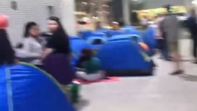 Screenshots from a video uploaded to social media shows fans camping out in tents at a loading dock at Pacific Fair.