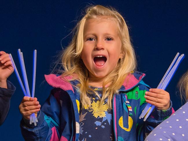 The glowstick vendor has been banned from the Ivanhoe's blvd christmas lights festival by the council. Sisters l-r Vaiva, 5, Kira, 3 and Nina, 7 have fun with their glow sticks. Picture: Jason Edwards