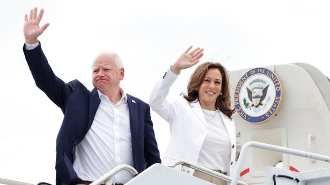 US Vice President and 2024 Democratic presidential candidate Kamala Harris and her running mate Minnesota Governor Tim Walz wave as they board Air Force Two, departing Chippewa Valley Regional Airport in Eau Claire, Wisconsin, in the US, on August 7, 2024. (Photo by KAMIL KRZACZYNSKI / AFP)