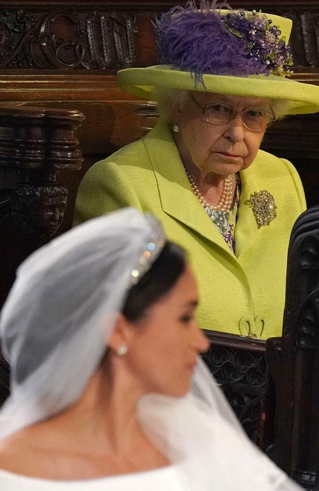 The bride, in Givenchy (front), as the Queen looked on. The monarch is said to be infuriated at Prince Harry and Meghan Markel’s decision to leave the royal family. Picture: AFP