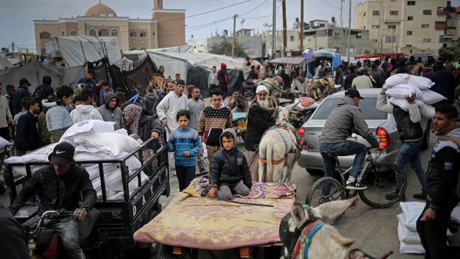 A Palestinian man transports sacks of humanitarian aid in a vehicle outside the distribution centre of the United Nations Relief and Works Agency for Palestine Refugees (UNRWA), in Rafah in the southern Gaza Strip on March 3 amid the ongoing conflict between Israel and the Hamas movement. Picture: AFP