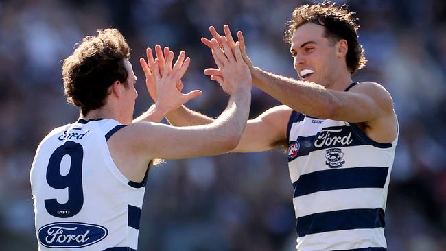 GEELONG, AUSTRALIA - AUGUST 24: Jack Bowes of the Cats celebrates with Max Holmes of the Cats during the round 24 AFL match between Geelong Cats and West Coast Eagles at GMHBA Stadium, on August 24, 2024, in Geelong, Australia. (Photo by Kelly Defina/Getty Images)