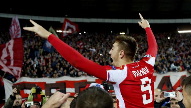 Red Star's Milan Pavkov celebrates with fans following his team’s Champions League victory over Liverpool. Photo: AP