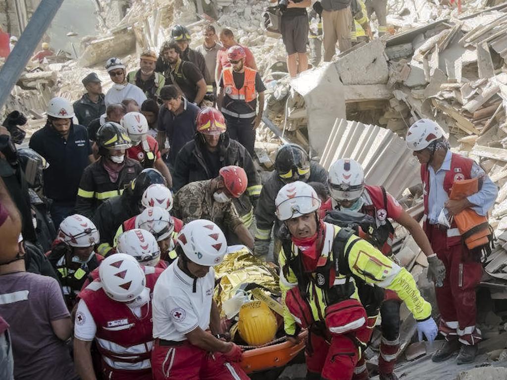 A survivor is pulled out of the rubble in Amatrice, central Italy, where a 6.1 earthquake struck just after 3:30 a.m., Wednesday, Aug. 24, 2016. The quake was felt across a broad section of central Italy, including the capital Rome where people in homes in the historic center felt a long swaying followed by aftershocks. (AP Photo/Emilio Fraile)