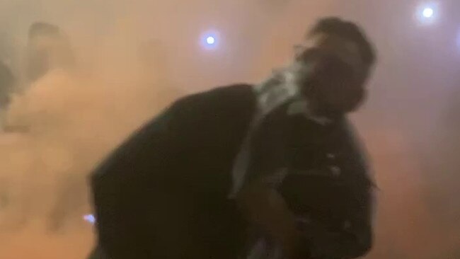 Police have released images and video of a man throwing a flare at Monday's pro-Palestine rally as they investigate "unlawful activity" at the protest, which turned violent.