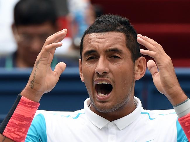 Nick Kyrgios of Australia reacts after talking with the umpire during a break in his men's singles second round match against Kei Nishikori of Japan at the Shanghai Masters tennis tournament in Shanghai on October 14, 2015. AFP PHOTO / GREG BAKER