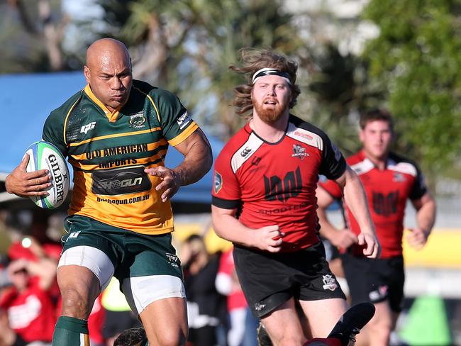 Pila Fifita (left) of Surfers Paradise Dolphins breaks free from a challenge by Chris Manby of Griffith College Knights during the Gold Coast District Rugby Union grand final played at the James Overall Park, Southport, Gold Coast. Photo: Regi Varghese