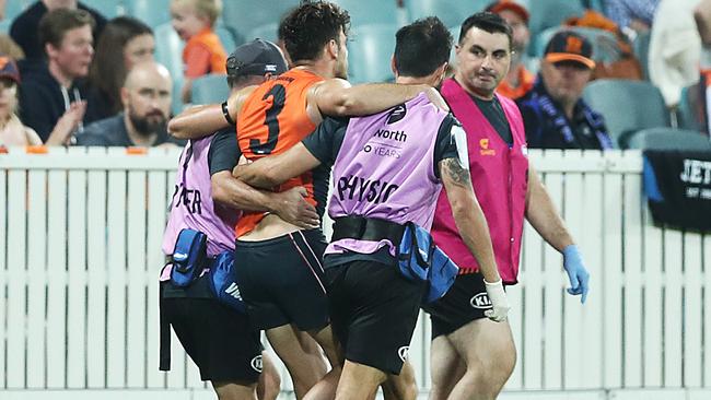 Coniglio limped from the field in the hands of trainers. Picture: AFL Photos/Getty Images