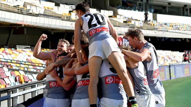 Power players swamp Robbie Gray after he kicked the winning goal after the siren against Carlton. Picture: Bradley Kanaris/Getty Images