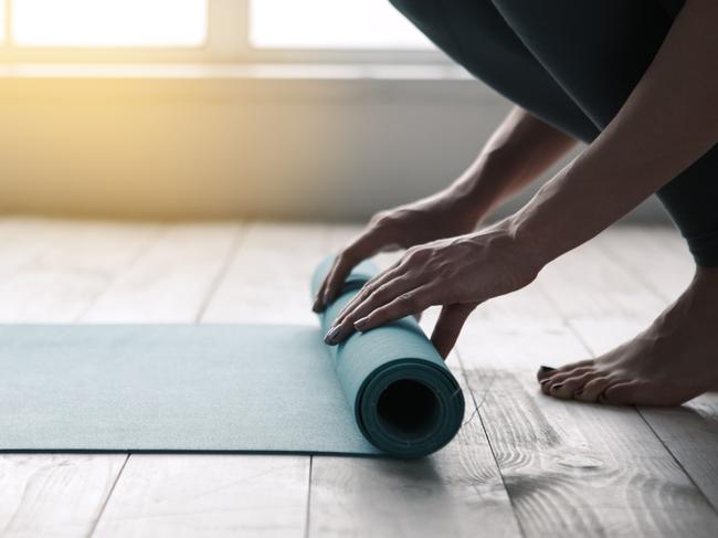 ESCAPE: Story on things you can ask for in a hotel room, by Lisa Mayoh. iStockYoung woman doing yoga twisting mat indoors near window