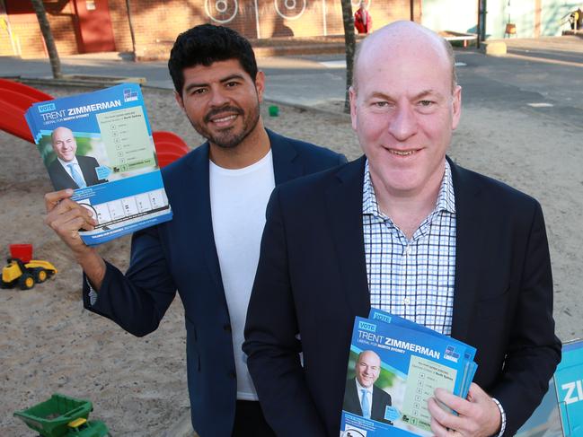 Mr Zimmerman and partner Carlos Toledo welcomed voters this morning. Picture: AAP Image/Mark Scott