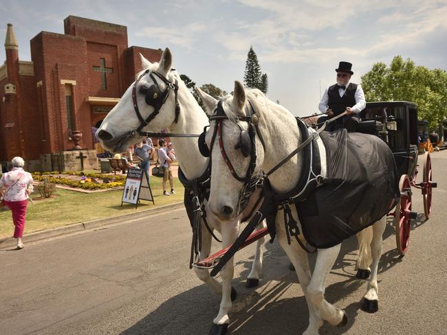 A vintage horse-drawn hearse is driven past the mausoleum to commemorate the 150-year anniversary of Rookwood cemetery in Sydney’s west. Picture: AFP/Peter Parks