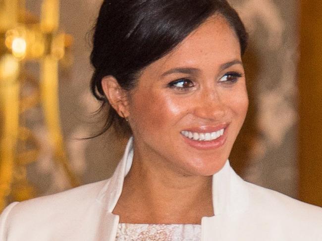 TOPSHOT - Britain's Prince Harry, Duke of Sussex, (L) and Britain's Meghan, Duchess of Sussex (R) attend a reception to mark the 50th Anniversary of the investiture of The Prince of Wales at Buckingham Palace in London on March 5, 2019. - The Queen hosted a reception to mark the Fiftieth Anniversary of the investiture of Britain's Prince Charles, her son, as the Prince of Wales. Prince Charles was created The Prince of Wales aged 9 on July 26th 1958 and was formally invested with the title by Her Majesty The Queen on July 1st 1969 at Caernarfon Castle. (Photo by Dominic Lipinski / POOL / AFP)