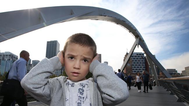 Stefan 4, blocks his ears from the noise of all the loose panels on the Evan Walker Bridge. Picture: David Caird