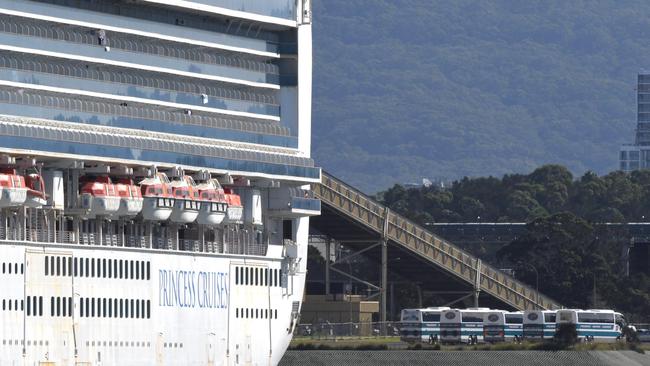 Buses line up on the dock to ferry almost 50 crew to Sydney. Picture: Simon Bullard