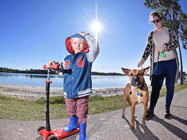 WEATHER: Out enjoying the winter sun along the Maroochy River are Arlie, 3, and Tasha Everson with their dog Olive. Photo Patrick Woods / Sunshine Coast Daily.