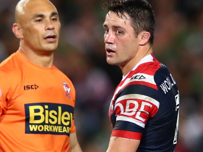 Cooper Cronk with the Roosters trainer after he injured his left shoulder during Saturday night’s preliminary final. Picture: Getty Images