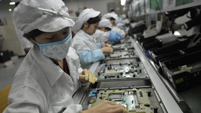 A file photo shows Chinese workers in a Foxconn factory in Shenzhen, in southern China. Picture: AFP