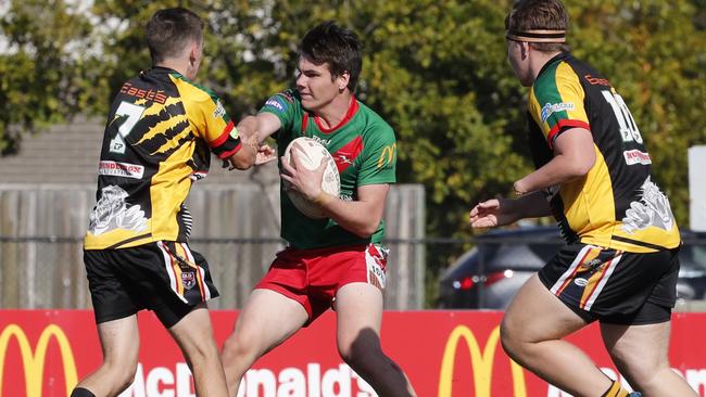 Andrew O'Toole (centre) of Wynnum Manly and Trent Mehlert (left) of Rochedale during the Under-17 rugby league competition. Picture: AAP Image/Regi Varghese