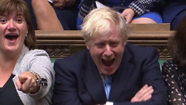 Boris Johnson (R) and Culture Secretary Nicky Morgan (L) reacT as Jeremy Corbyn speaks against Mr Johnson’s motion for an early parliamentary general election. Picture: AFP.