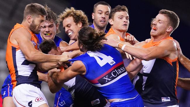 Marcus Bontempelli of the Bulldogs and players wrestle at the end of the third quarter during the Round 3 AFL match between Western Bulldogs and GWS Giants at Marvel Stadium in Melbourne, Friday, June 19, 2020. (AAP Image/Scott Barbour) NO ARCHIVING, EDITORIAL USE ONLY