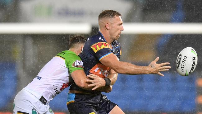 GOLD COAST, AUSTRALIA - MARCH 17: Bryce Cartwright of the Titans offloads during the round 1 NRL match between the Gold Coast Titans and the Canberra Raiders at Cbus Super Stadium on March 17, 2019 in Gold Coast, Australia. (Photo by Bradley Kanaris/Getty Images)