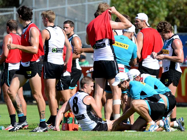 Hamish Hartlett is attended to at Port Adelaide training. Picture: Tricia Watkinson