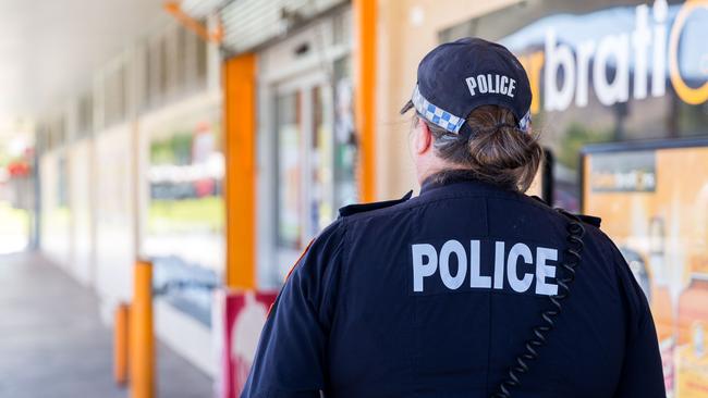 A police officer conducting a point of sale intervention in Alice Springs.