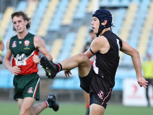 Saints' Cooper Brennan gets a kick away in the AFL Cairns Under 17B grand final match between the Cairns Saints and the South Cairns Cutters, held at Cazalys Stadium, Westcourt. Picture: Brendan Radke